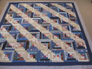 scrappy log cabin top in shades of blue and beige
