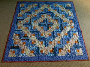 barn raising log cabin quilt in blue and ivory